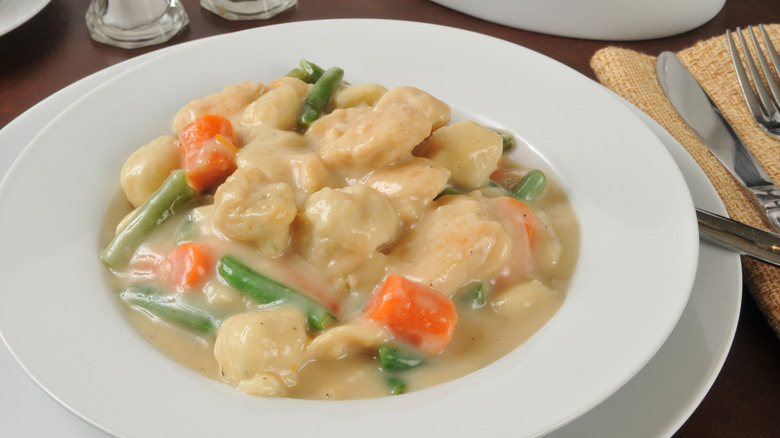 White bowl of chicken and dumplings