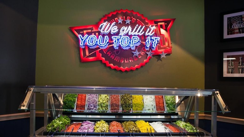 A Fuddruckers build your own topping bar.