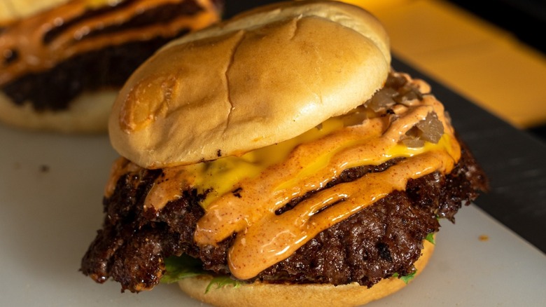 Smash burgers in buns with melted cheese, at Hammy's