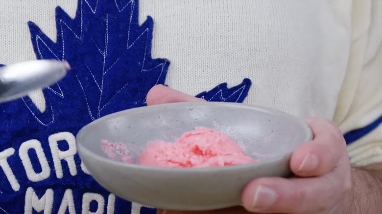 A man holds a bowl of Jell-O ice cream and a spoon
