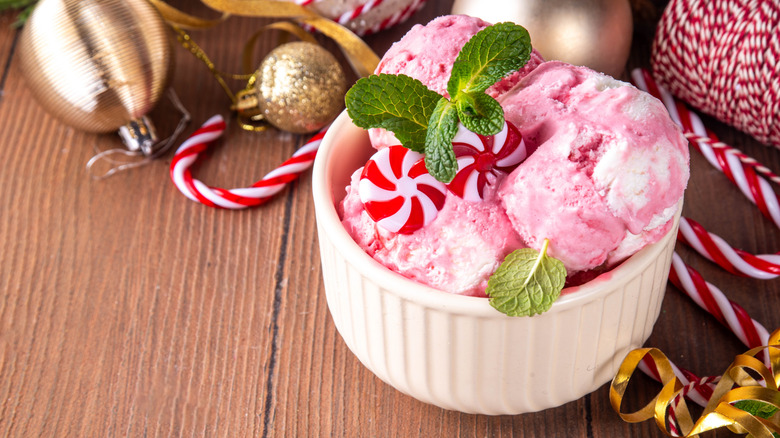 Bowl of peppermint ice cream, with peppermint candy and baubles surrounding it