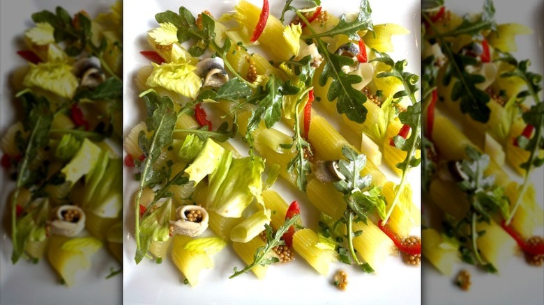 A plate of Celery Victor salad topped with fresh greens