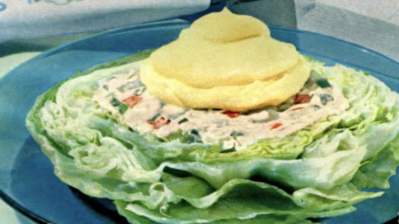 Vintage deviled lettuce salad topped with Miracle Whip
