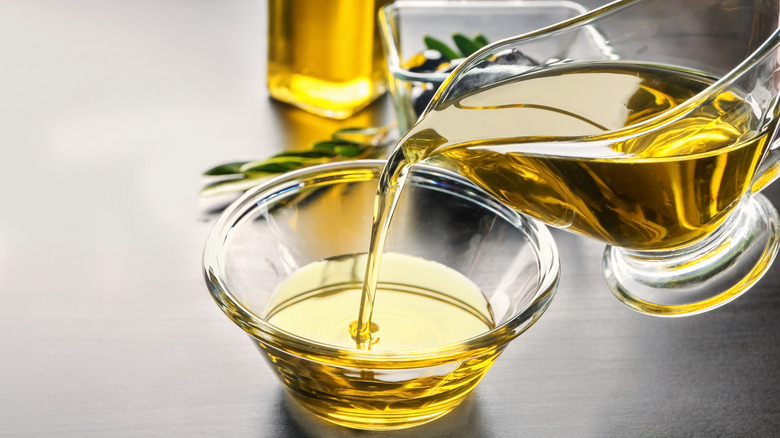 Pouring oil into glass bowl