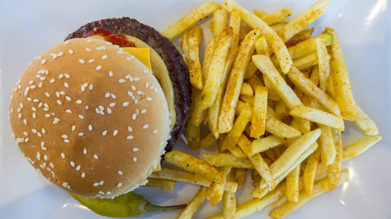 Burger and fries, with jalapeño pepper next to them