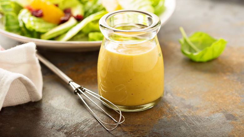 Mini whisk next to dressing