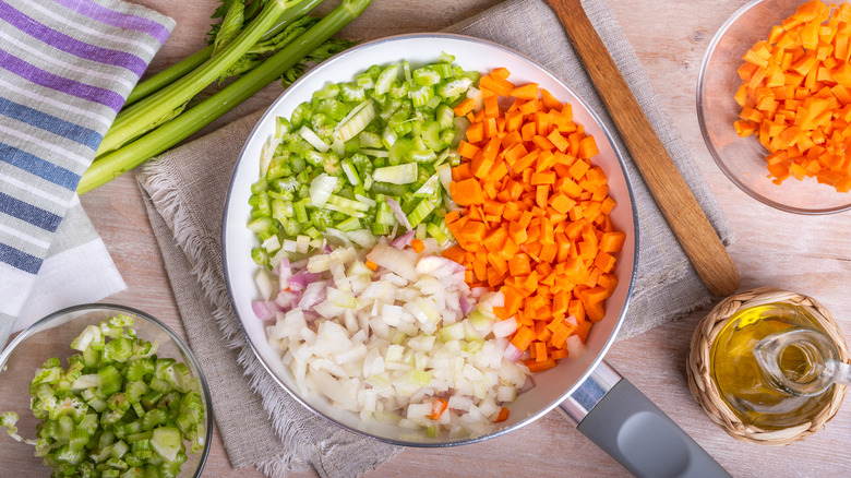 Diced onions, carrots, and celery in a saute pan