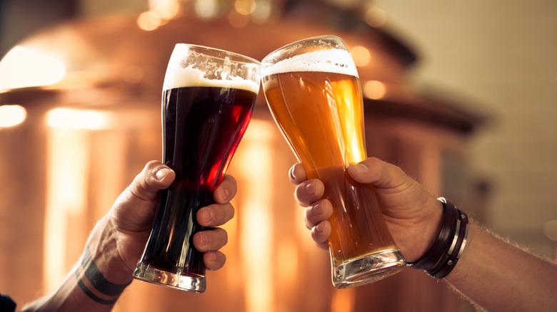 Light beer and dark beer cheersing