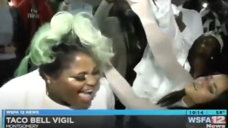Woman singing at the Taco Bell candlelight vigil