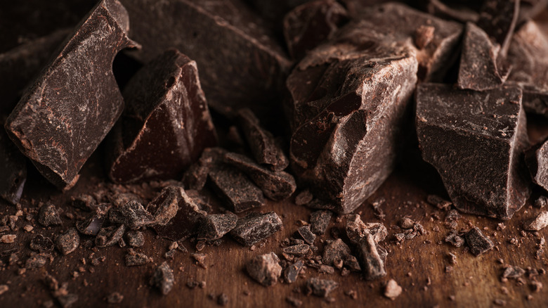 Pieces of dark chocolate on table
