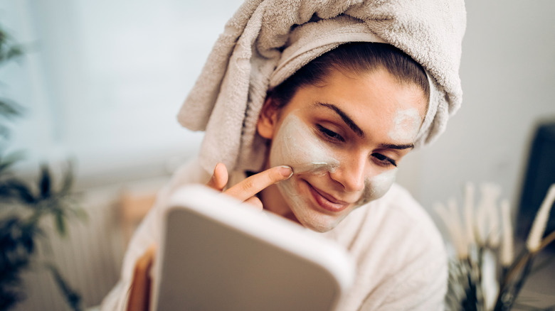 Woman applying skincare product