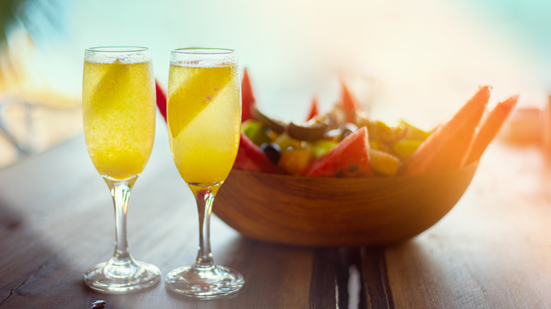 mimosas with fruit salad bowl