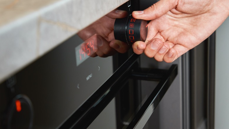 Woman preheating oven