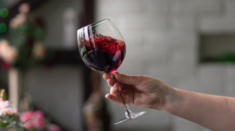 Person swirling a glass of wine