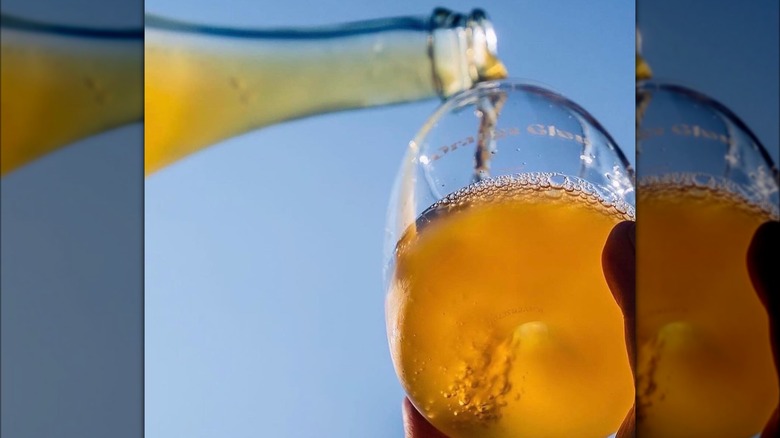 orange wine being poured