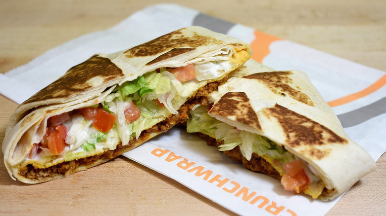A beef Crunchwrap Supreme from Taco Bell split in half to show the fillings