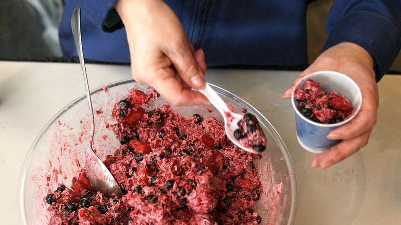 akutaq in mixing bowl being spooned into serving cup