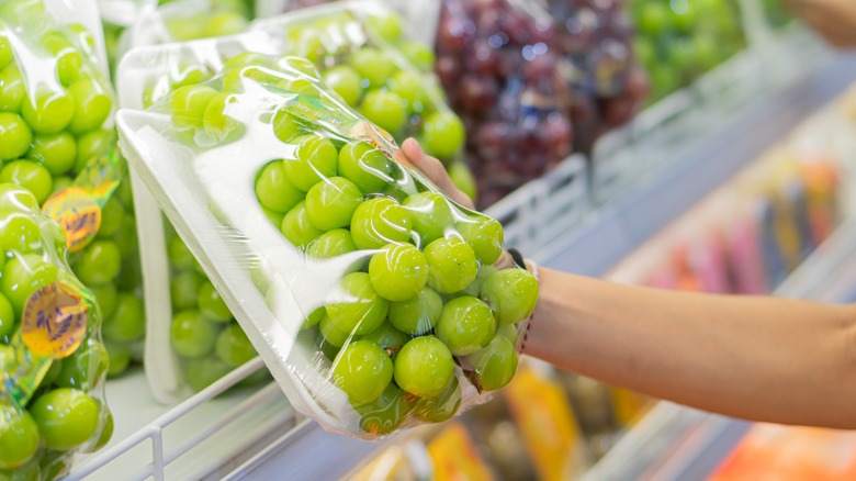 Customer shopping for grapes at a grocery store