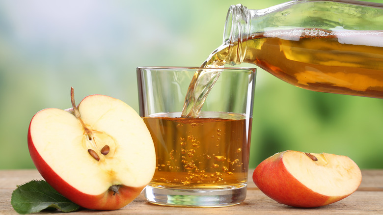 Glass of apple juice with apples