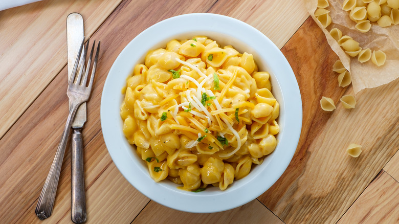 shells and cheese in a bowl with cutlery
