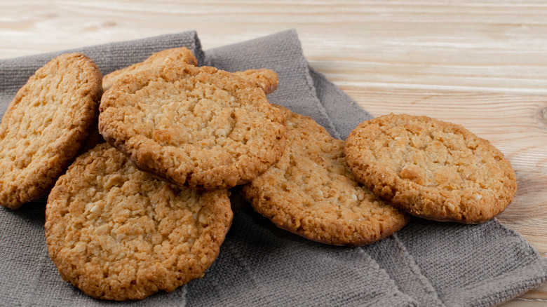 thin oatmeal cookies on kitchen towel