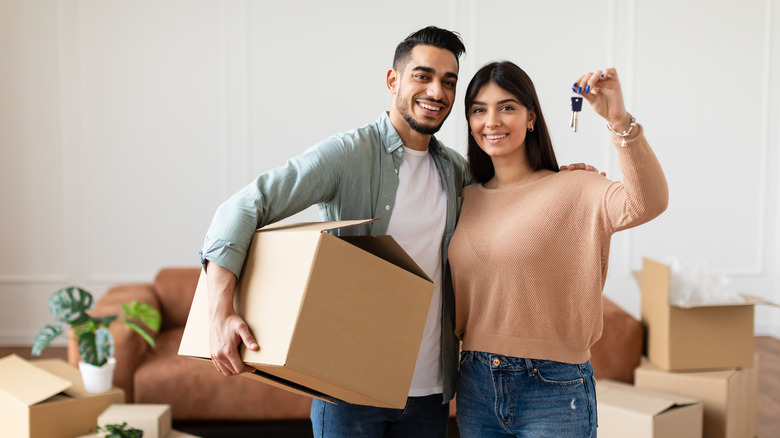 couple with keys to new house