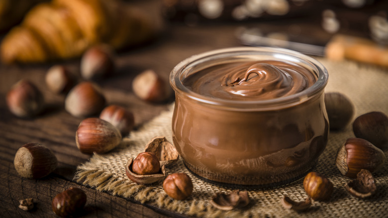Glass jar of Nutella on table