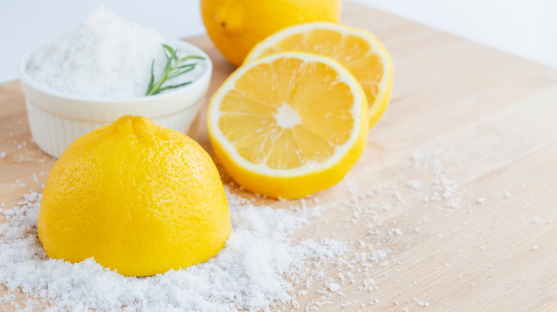 salt and lemon on wooden board