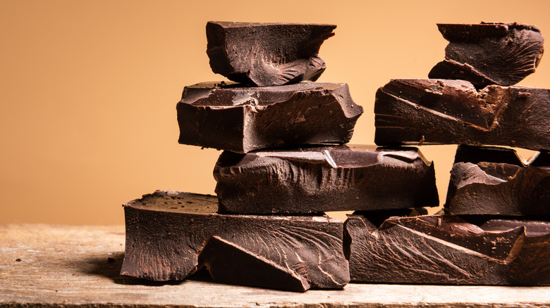 Pieces of broken chocolate against a tan background