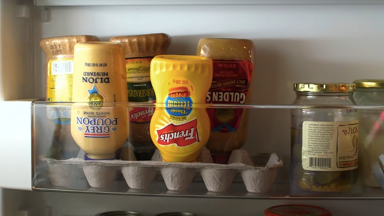 upside down mustard bottles in an egg carton