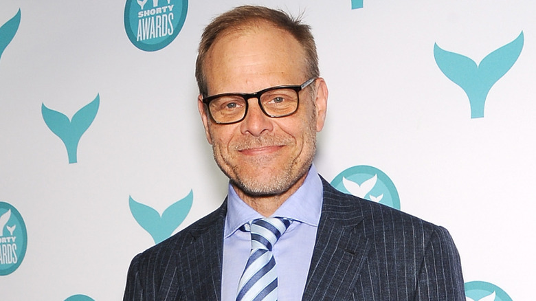 Alton Brown smiling on the red carpet
