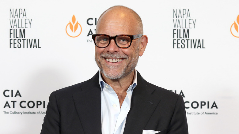 Alton Brown smiling on the red carpet
