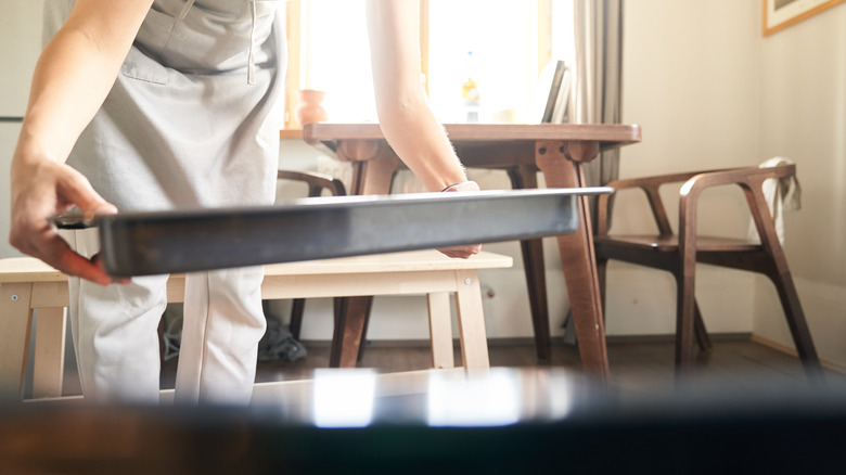 Person holding baking pan