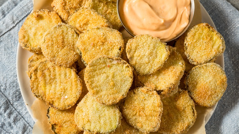 Plate of deep fried pickles and sauce