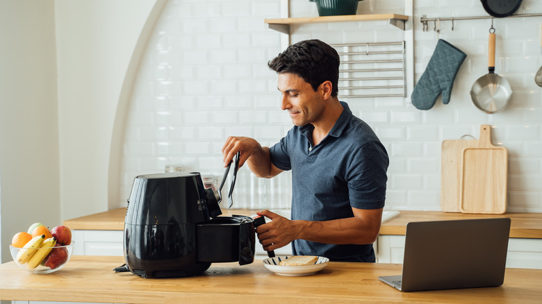 Man using an air fryer