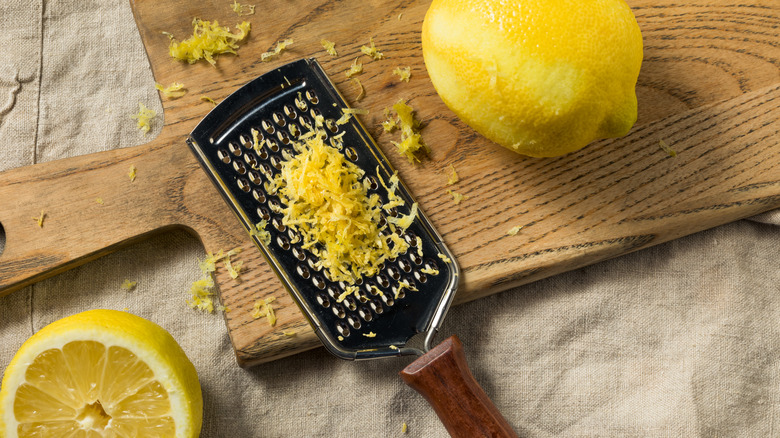 Rasp grater with lemons and zest