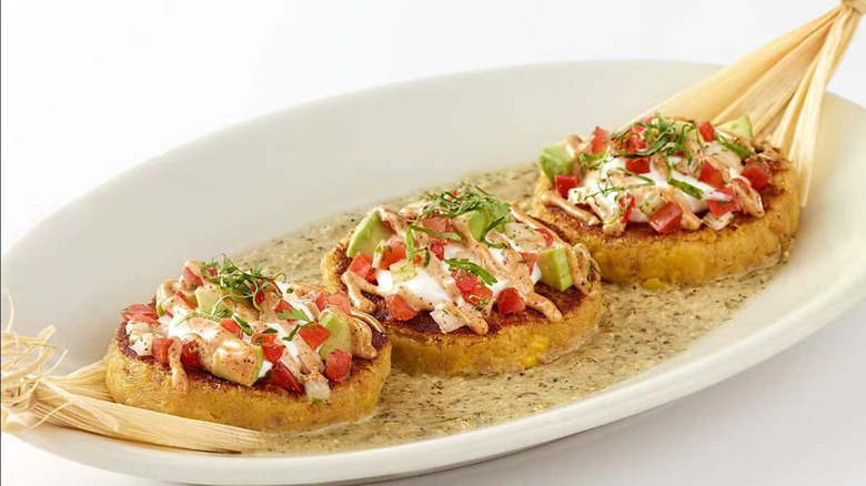 Cheesecake Factory's Sweet Corn Tamale Cakes isolated on a white dish