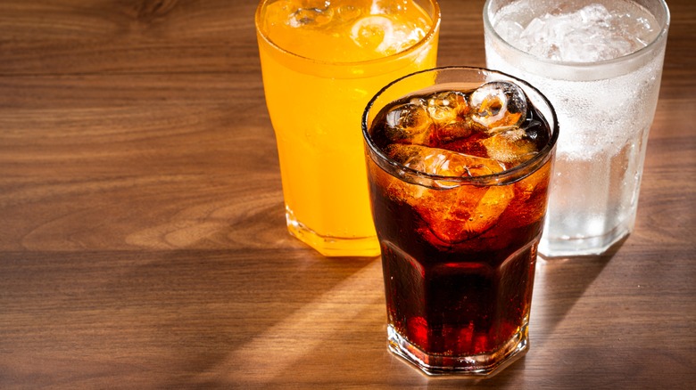 Glasses of different drinks on wood tabletop