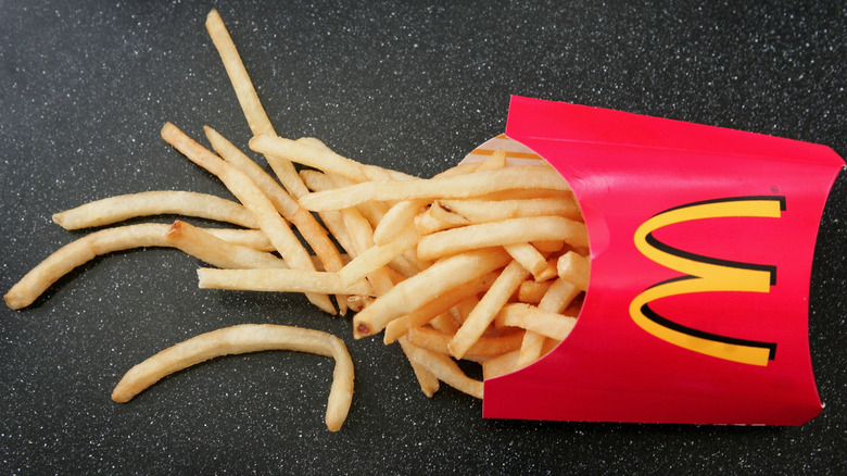 McDondald's fries spilling out of red box on table