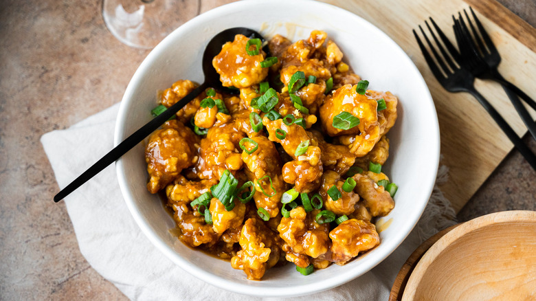 serving orange chicken in bowl