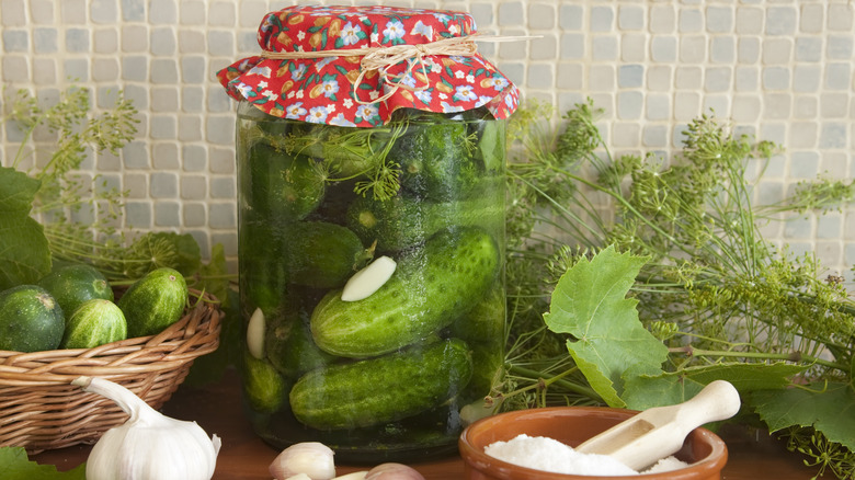 Jar of homemade pickles with herbs