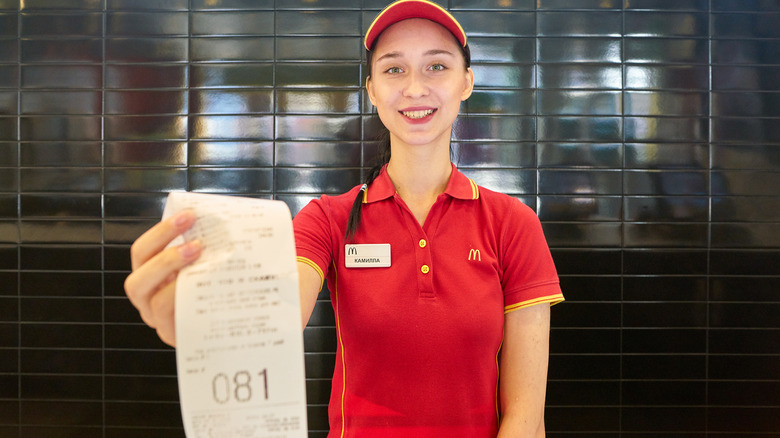 employee holding McDonald's receipt