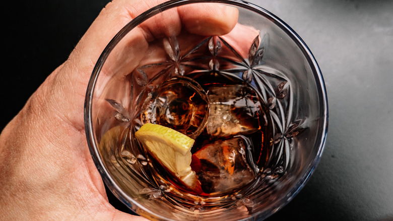 Top view of a whiskey and cola, with a slice of lemon