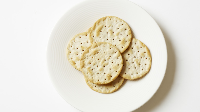 White plate with stack of water crackers