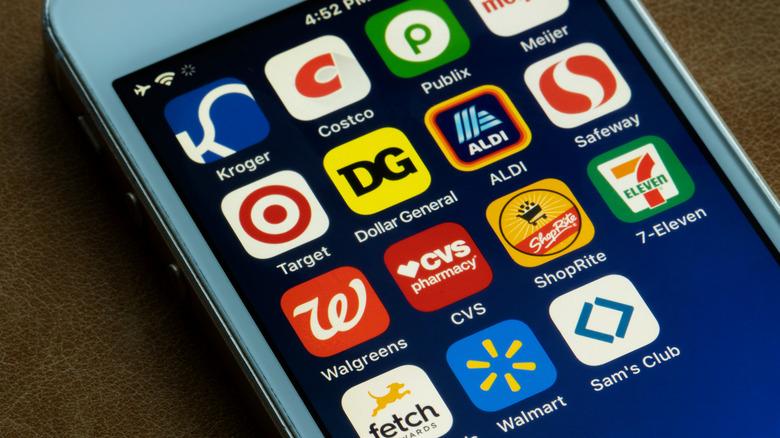 Smartphone with apps including Kroger, Costco, and Publix.