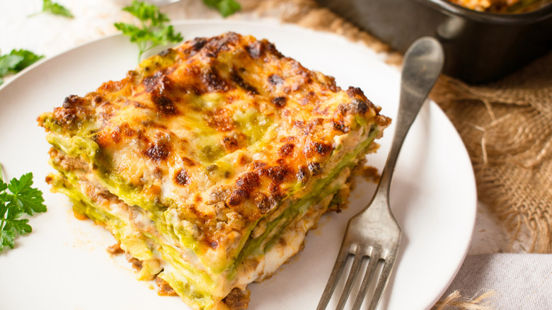 A large slice of traditional lasagna Bolognese with spinach pasta