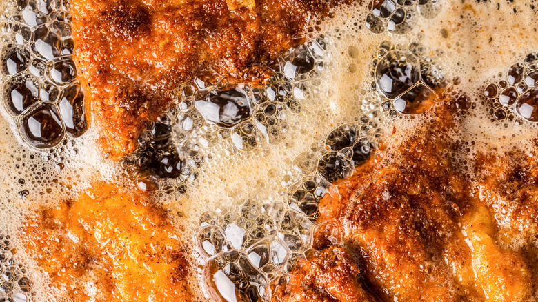 Fried food in bubbling oil