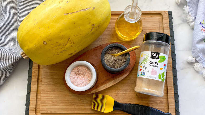 squash, oil, and seasonings on cutting board