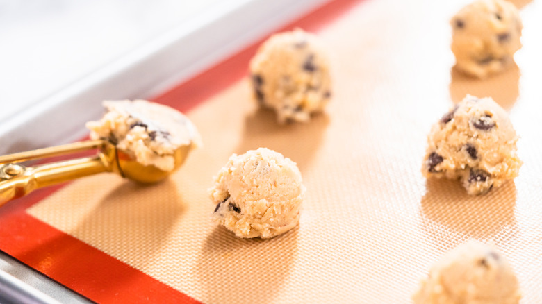 putting cookies dough on silicone mat