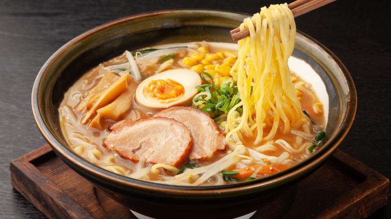 using chopsticks to pick up ramen